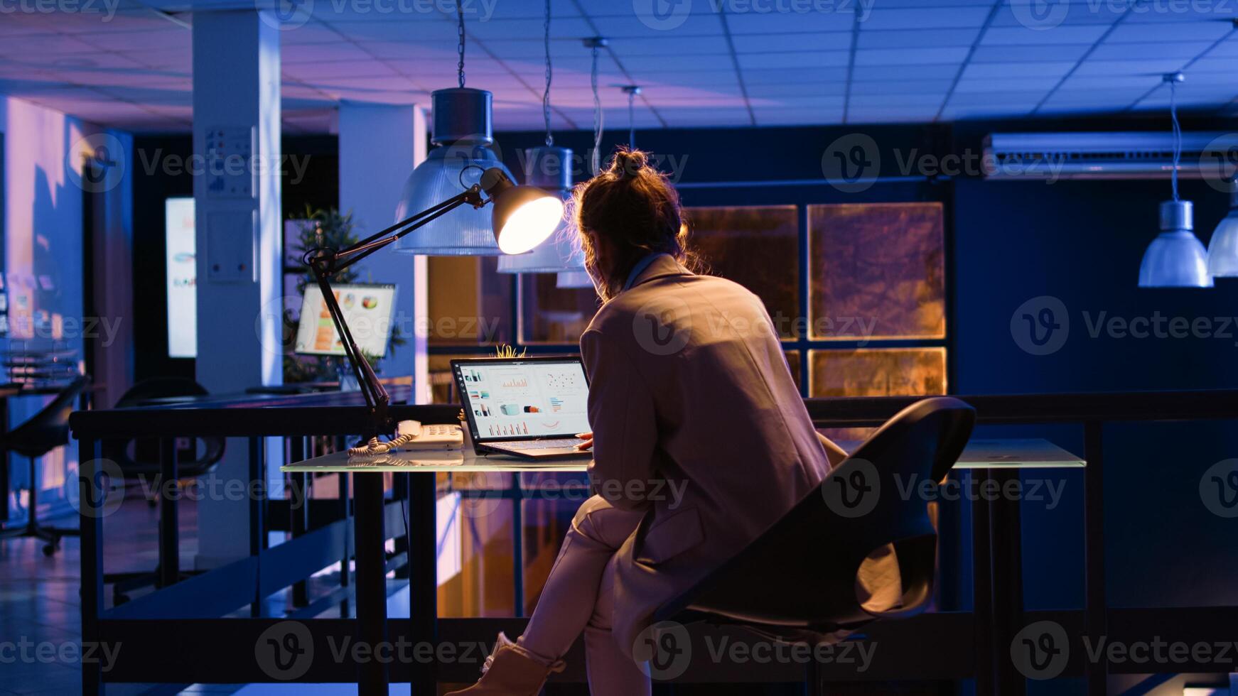 Female employee checking analytics and graphs on pc, looking at economy diagrams to create financial report for growth. Advisor working in business office, checking statistics. Handheld shot. photo