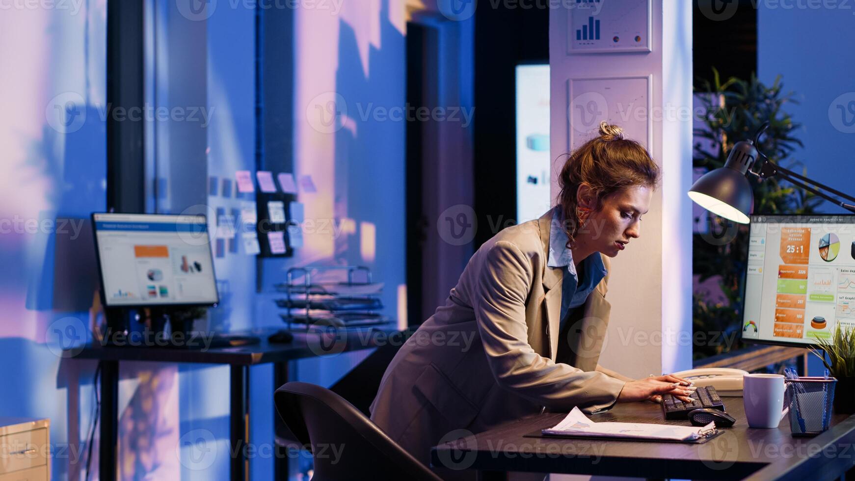 Business woman analyzing statistics on monitor and finishing management project before job deadline. Advisor agent working on financial diagrams and checking company analytics. photo