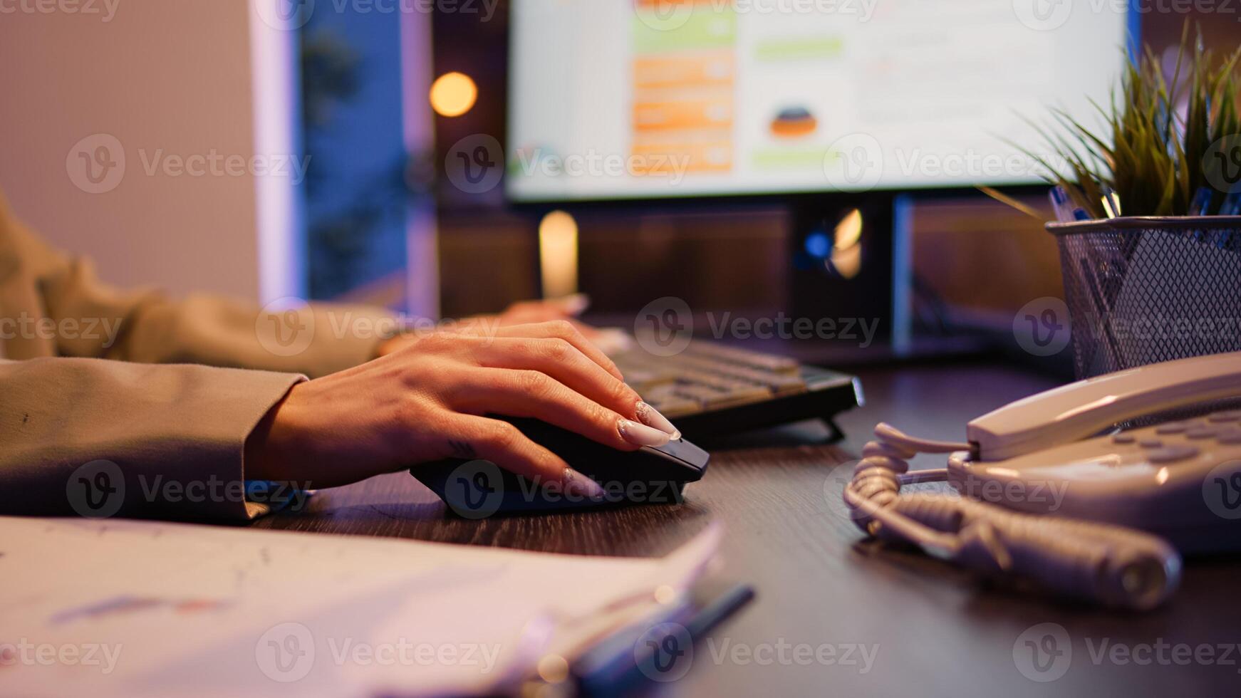 Office worker planning financial investment at night using computer before deadline. Woman checking business statistics at desk, analyzing diagrams to create project. Close up. Handheld shot. photo