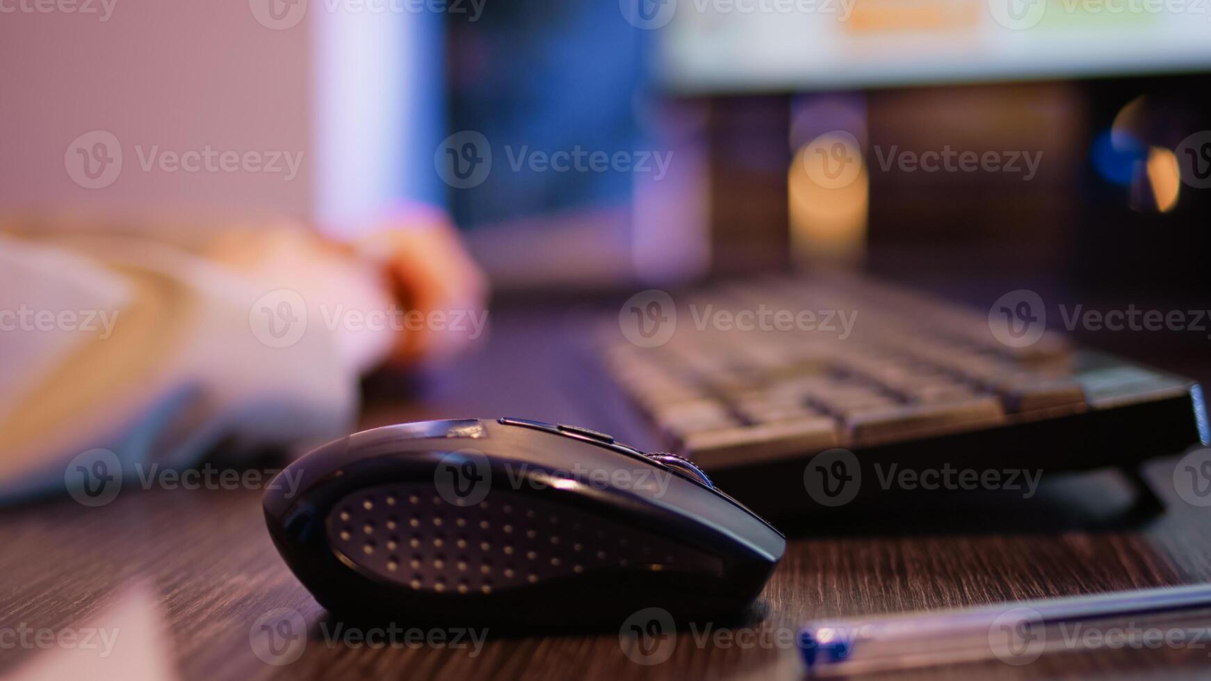 Corporate worker working on computer at desk and typing data to create financial report. Woman planning investment with statistics, trying to increase business profit. Tripod shot. Close up. photo