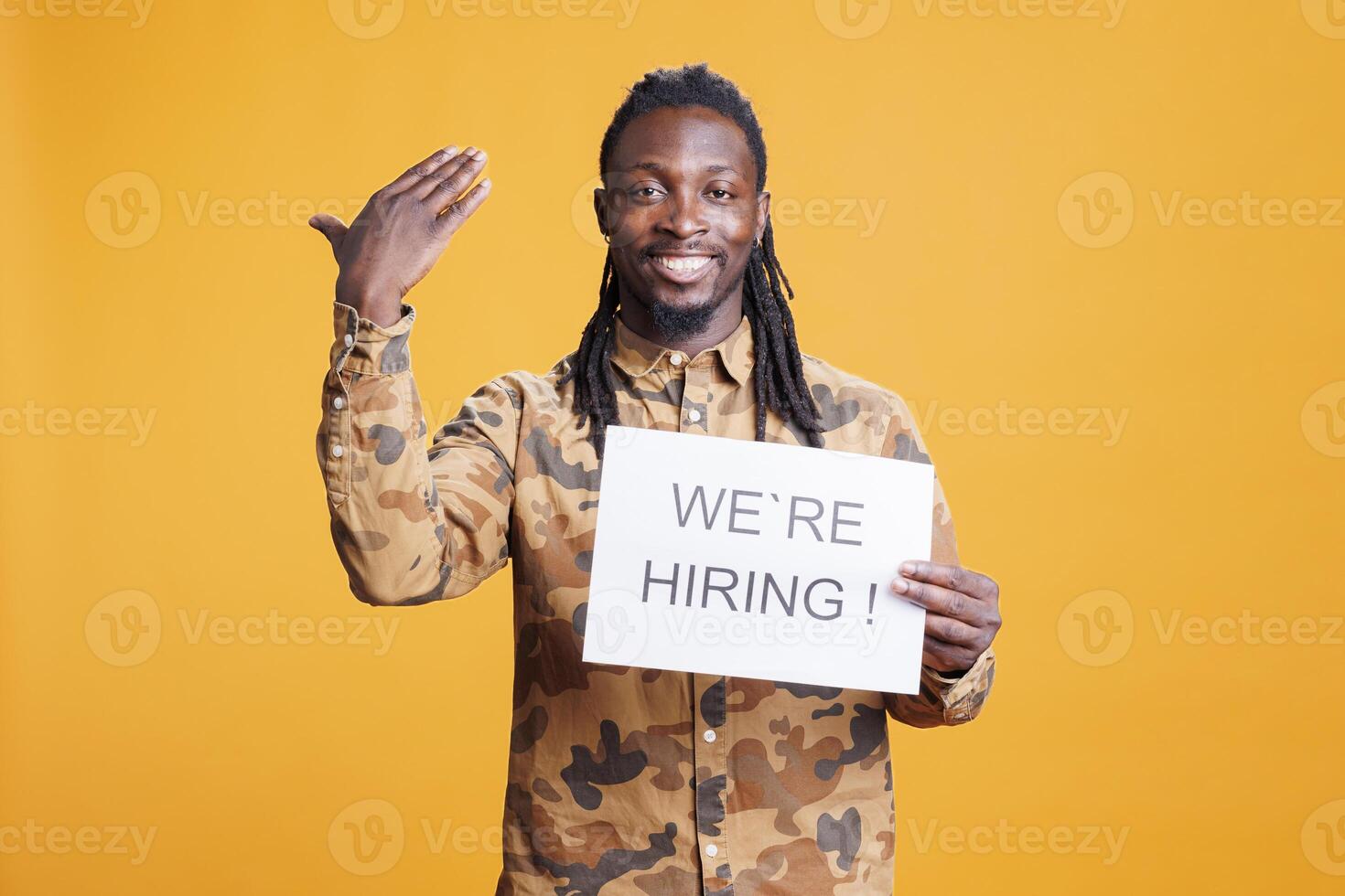 African american manager holding paper to make job offer in front of camera, hiring perfect candidate for career opportunity. Hr employee asking people to attend job interview in studio photo