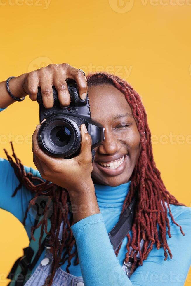 Female person taking photos with camera, having fun with images on vacation trip and sightseeing on cityscape. Young adult taking pictures of architecture and landmarks, photographs.