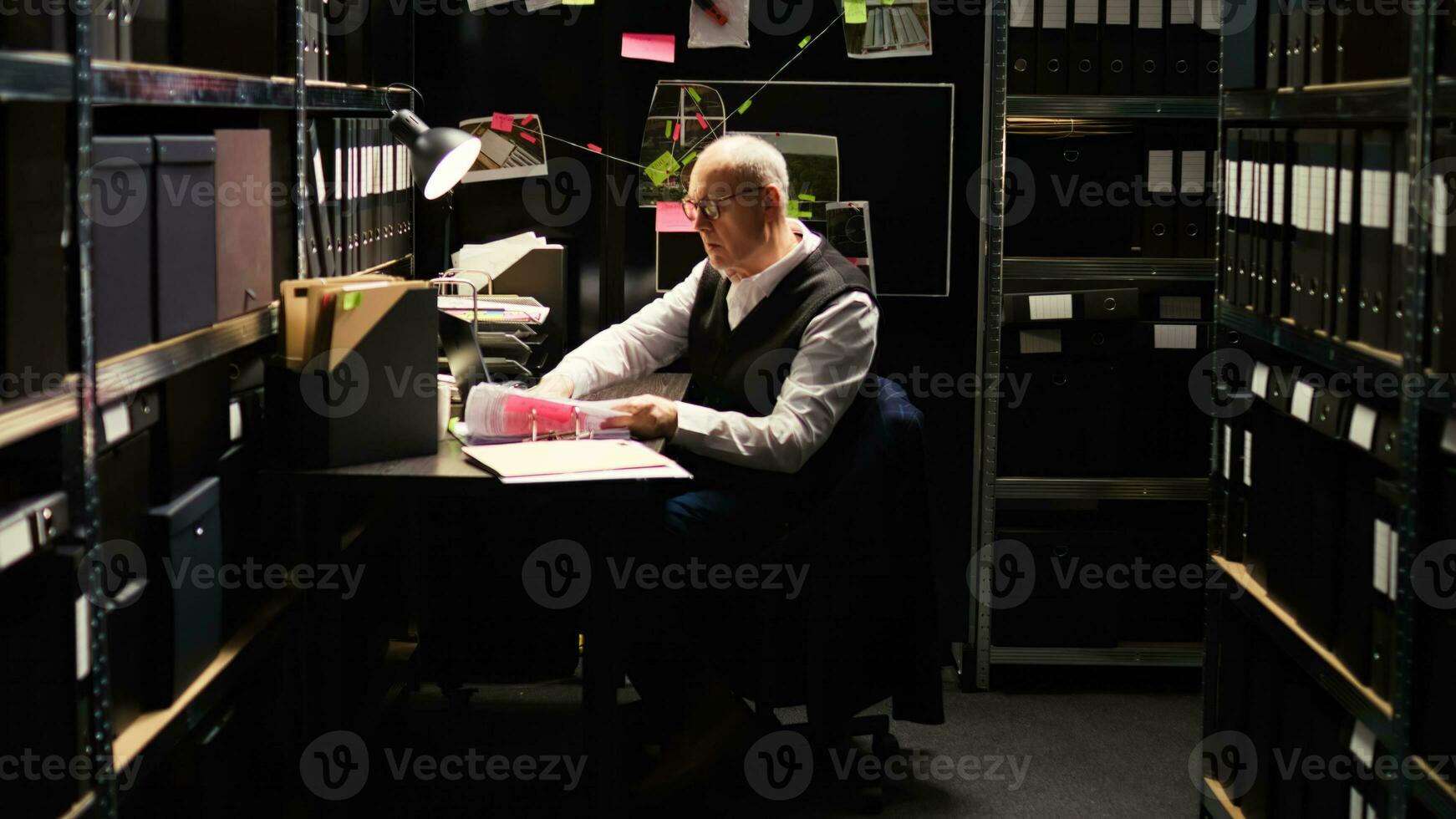 Law agent works on secret mission, private inspector examining classified records and case files in police incident room. Senior crime expert conducting investigation, forensic science. photo