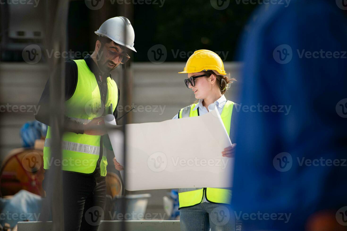 Engineer and architect working on the construction site, double-checking plans and process. photo
