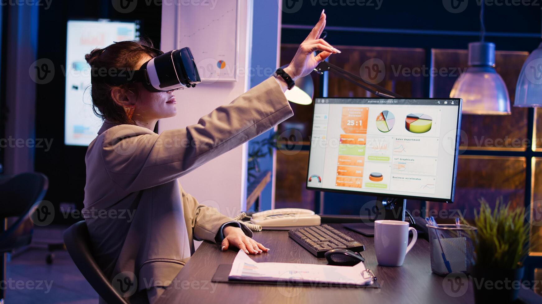 Young employee working late with vr headset, using virtual reality and 3d landscape on glasses. Executive manager planning financial development with interactive goggles. Handheld shot. photo