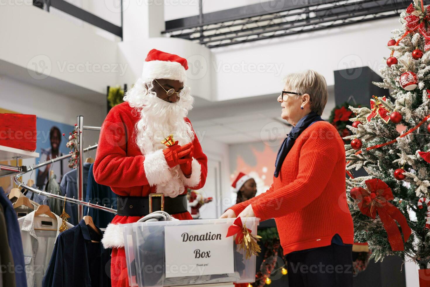 People filling out boxes for gifts to assist Santa Claus worker distribute Christmas spirit and donate to charities. Holiday generosity entails adults collecting clothes for children in need. photo