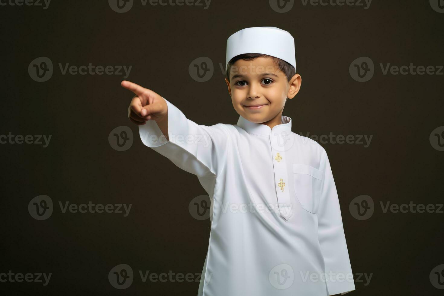 AI generated A young boy in traditional Muslim clothing, smiling and pointing with his finger. photo