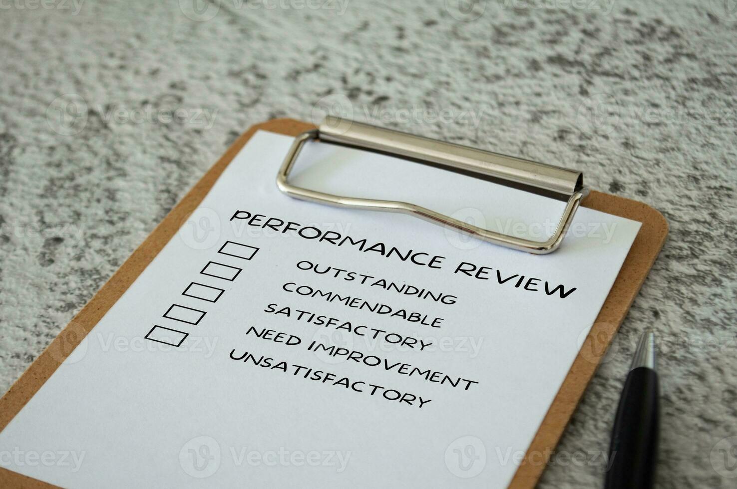 Performance Review checklist on clip board with pen. Performance review concept. photo