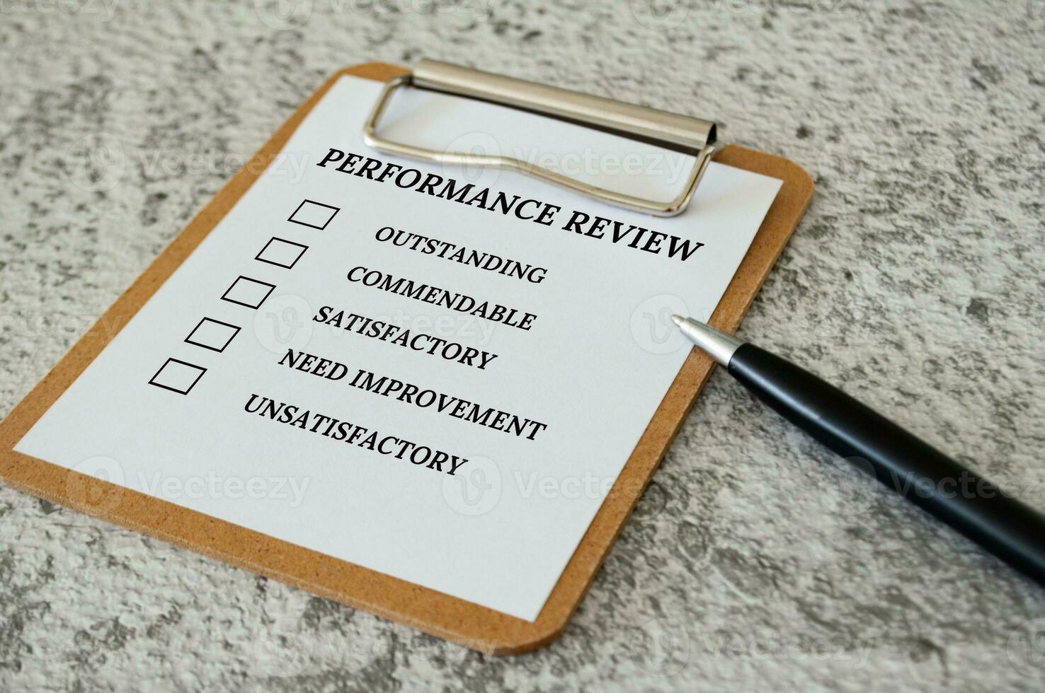 Performance Review checklist on clip board with pen. Performance review concept photo