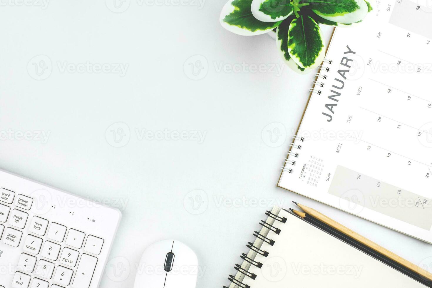 Top view of January calendar page. First month of new year on desk in white background. concept for planning and working goals in organization, cost, and income planning for startup new year photo