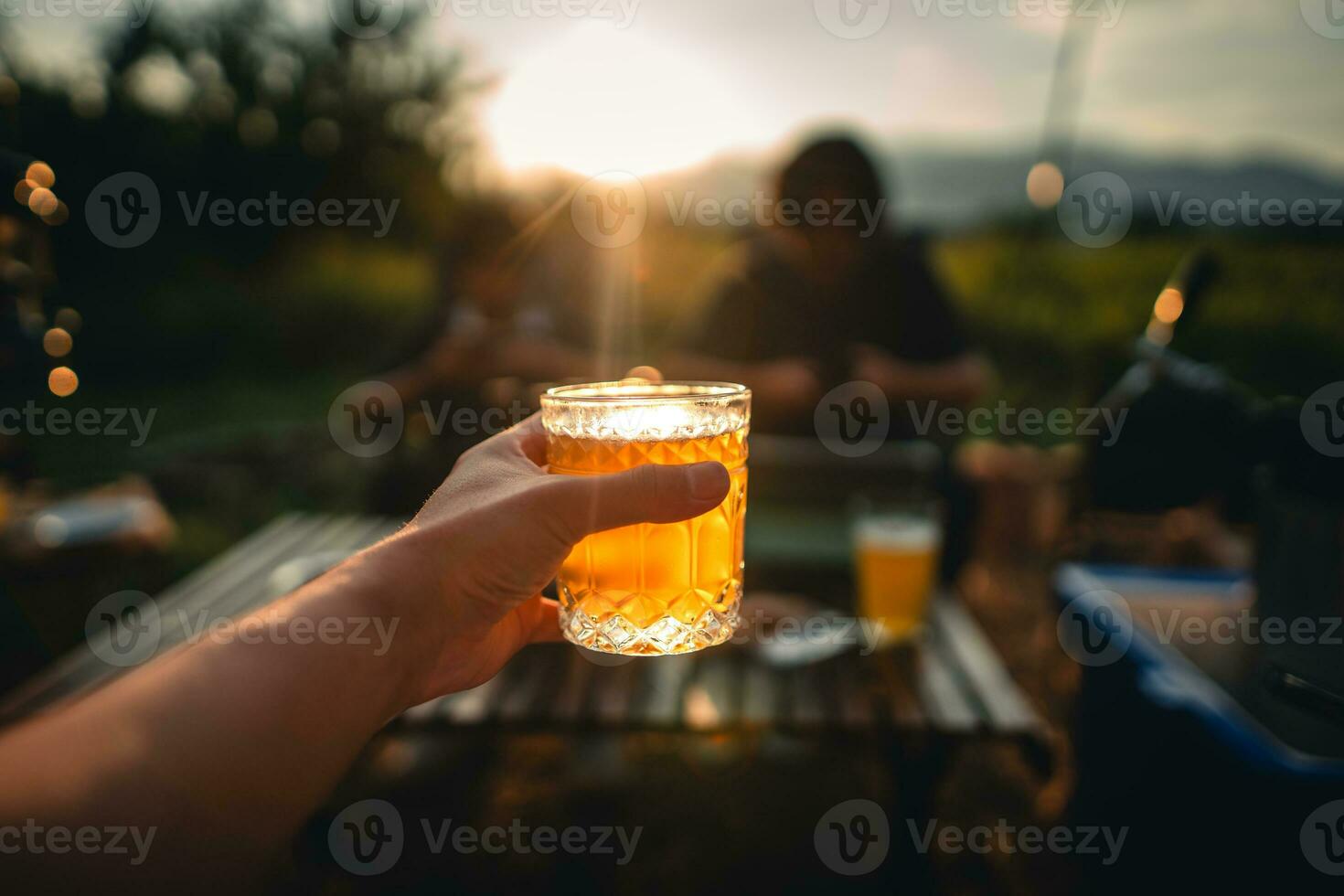 Beer on the table and camping party,hands toasting in beer, photo