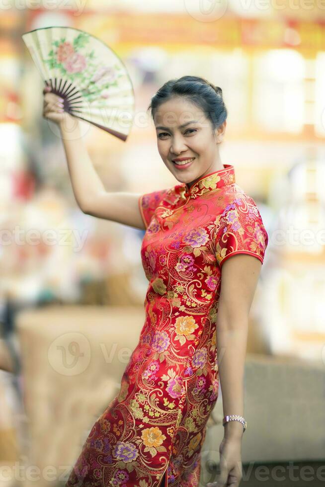 asian woman wearing chinese woman tradition clothes toothy smiling face in yaowarat street bangkok china town photo