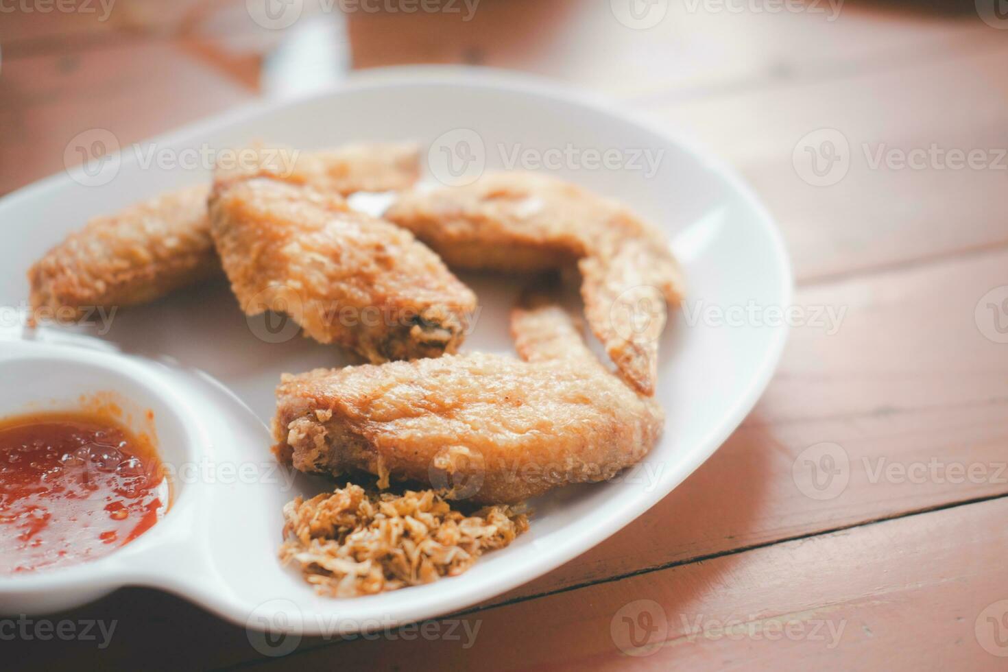 Close up fried chicken wings served with sweet sauce photo