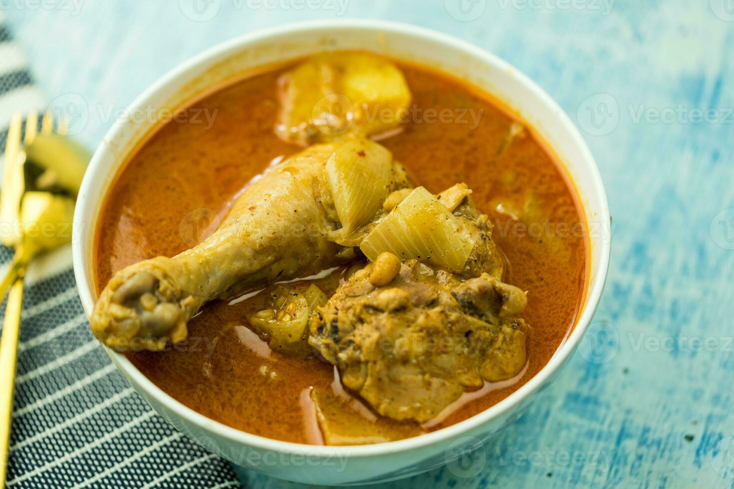 Thai chicken massaman curry in Thai, served in the white bowl photo