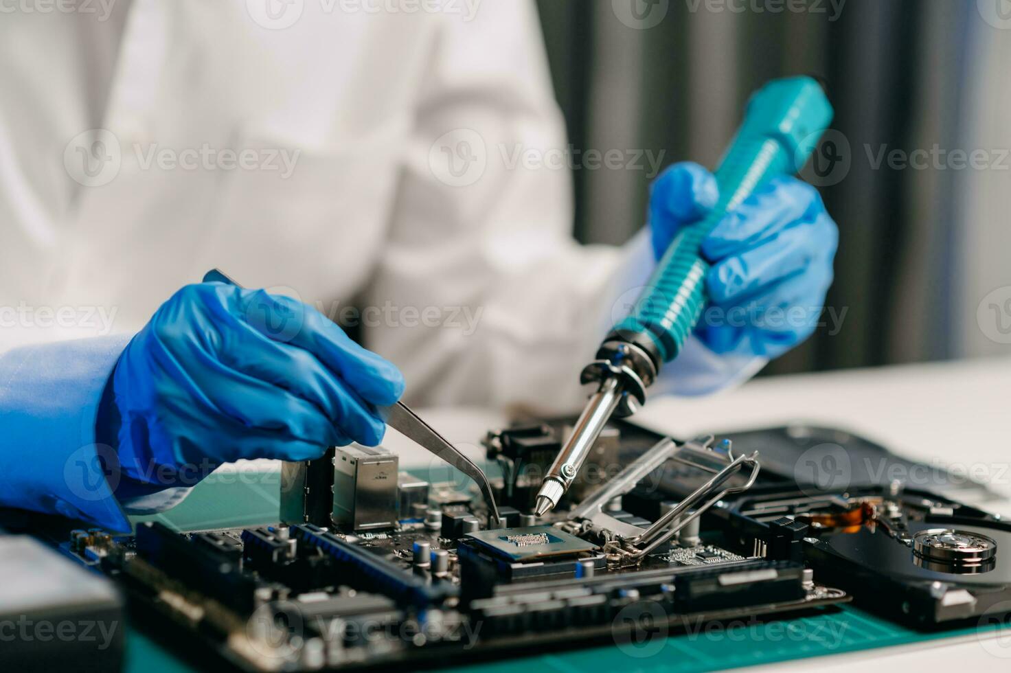 The technician is putting the CPU on the socket of the computer motherboard. electronic engineering electronic repair, electronics measuring and testing, repair photo