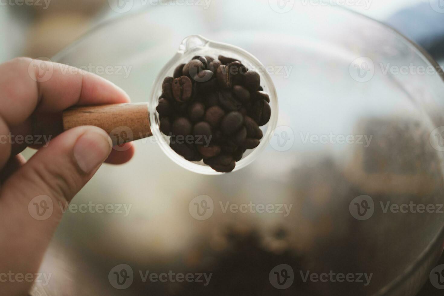 Roasted coffee beans in mini glass. photo