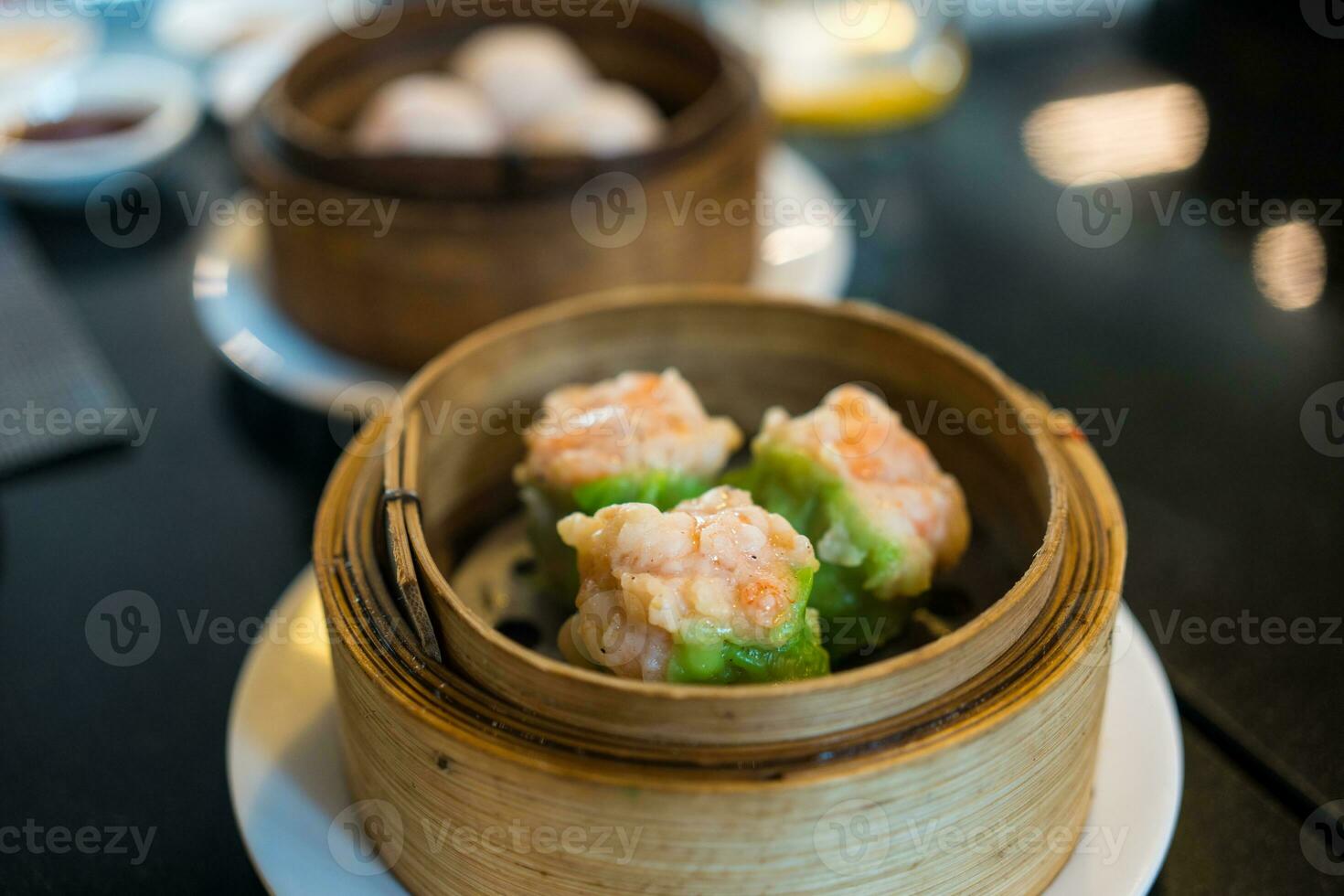 Hot steamed shrimp dumplings look delicious, dumplings recipe wrapped by green wonton wrapper photo