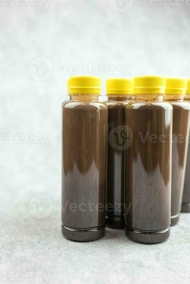 Cool fresh dark cocoa  in a plastic bottle with yellow lid quite popular take a home photo