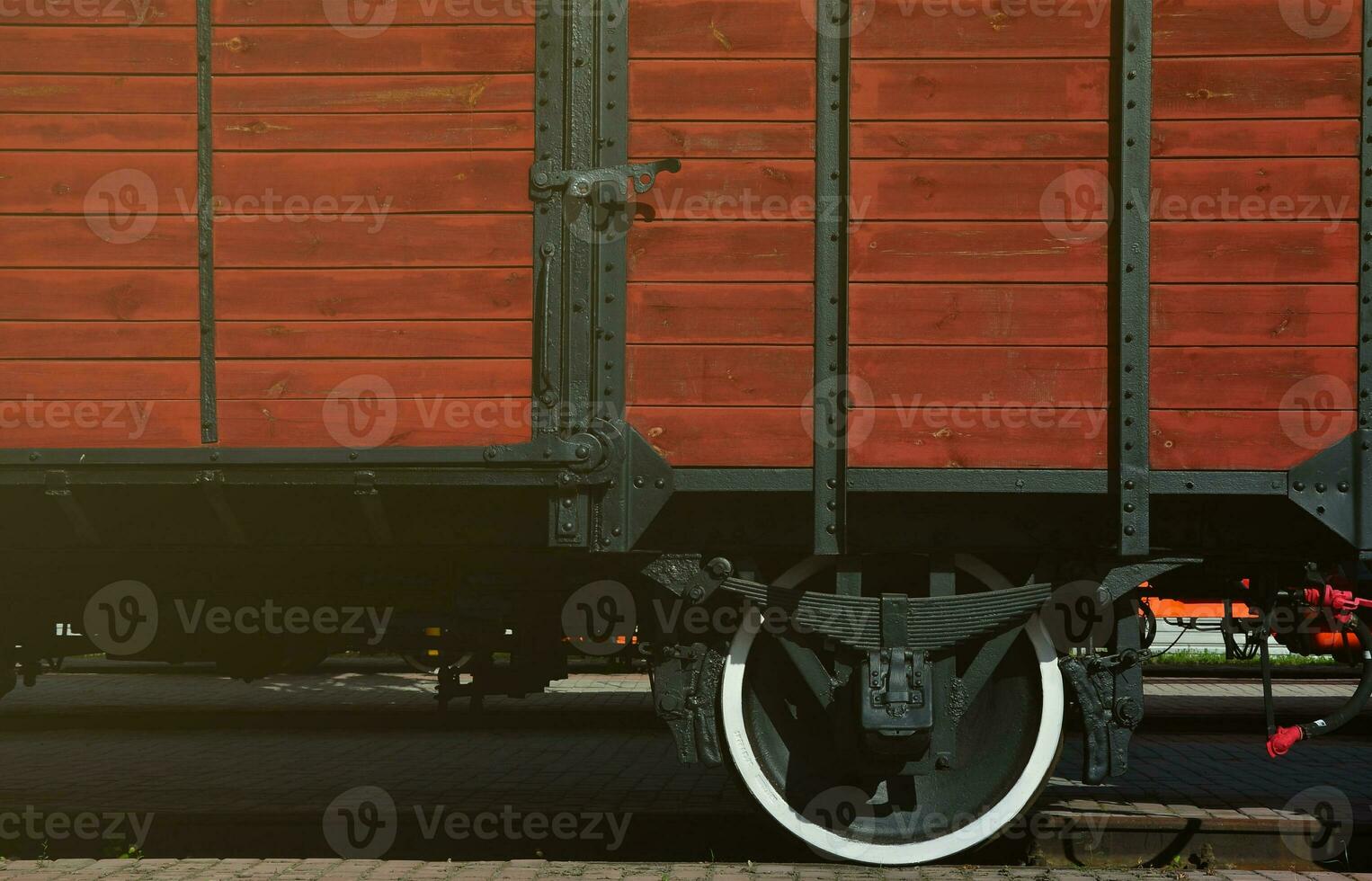 The side of the old brown wooden freight car with the wheel of the times of the Soviet Union photo
