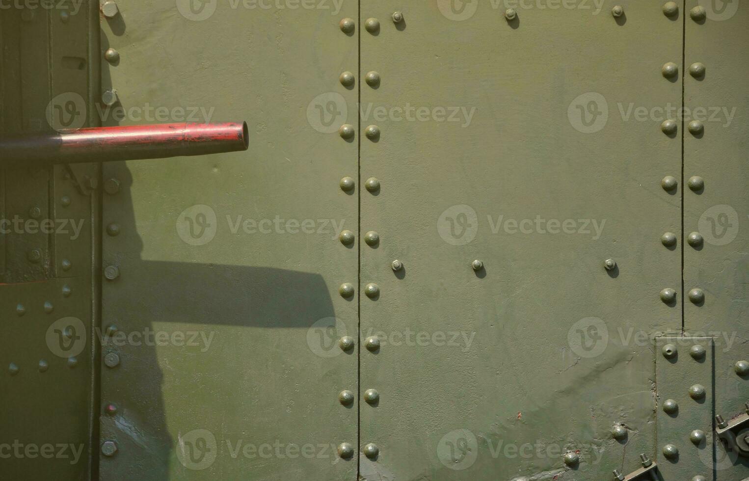 The texture of the wall of the tank, made of metal and reinforced with a multitude of bolts and rivets. Images of the covering of a combat vehicle from the Second World War with a guided machine gun photo