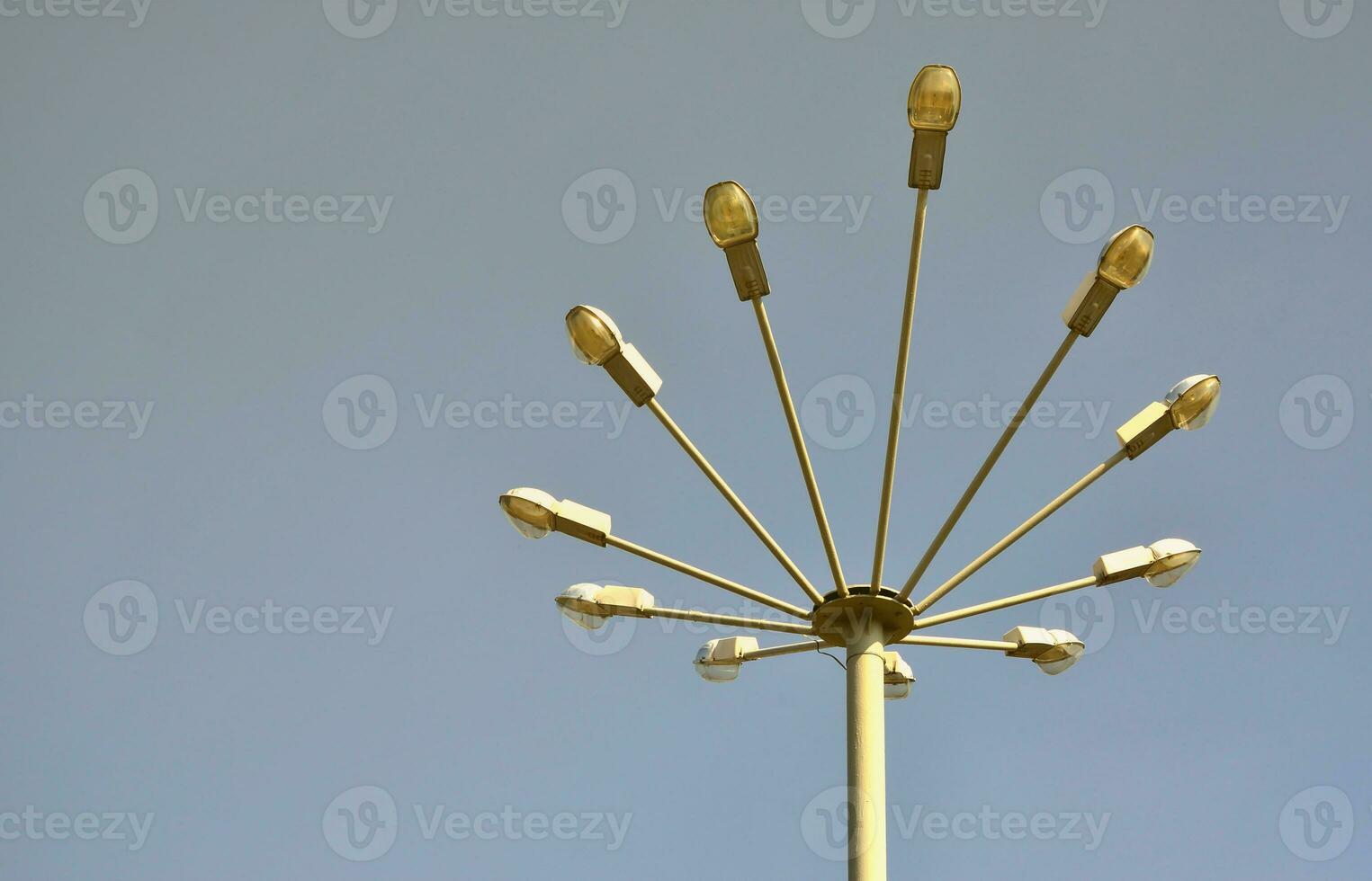 A street lamp consisting of a high pillar and a number of plafonds for light sources. Unusual view of street lighting in Ukraine photo