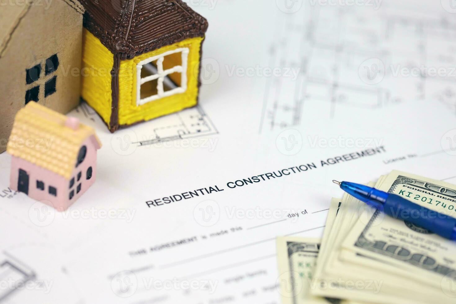 Residential construction agreement ready to sign with small toy houses and pen. Construction contract photo