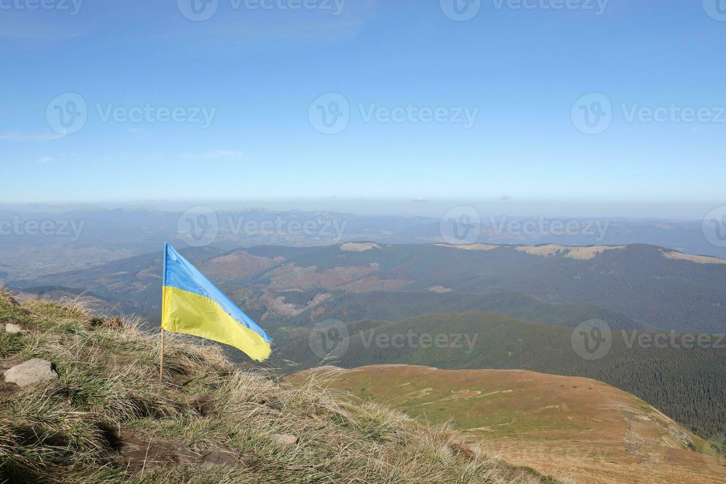 Ukrainian flag on top of Hoverla mountain in Ukraine photo