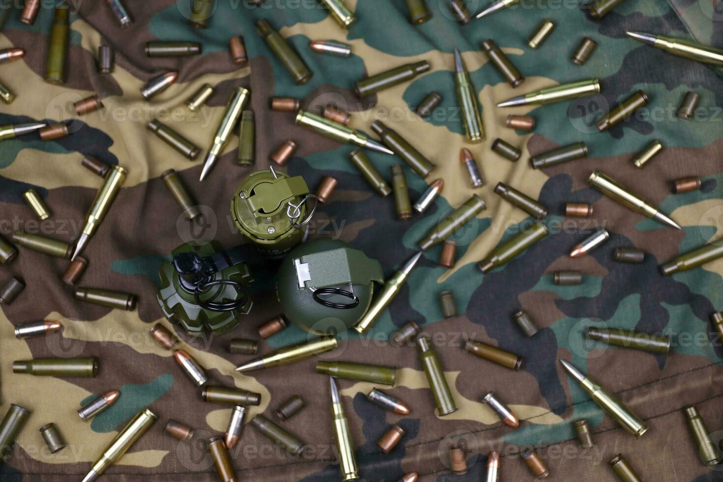 Different types of ammunition on a camouflage background. Preparing for war photo