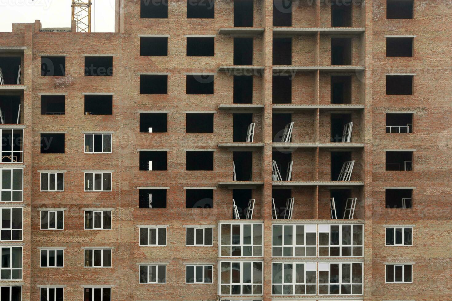 View of a large construction site with buildings under construction and multi-storey residential homes. Housing renovation photo