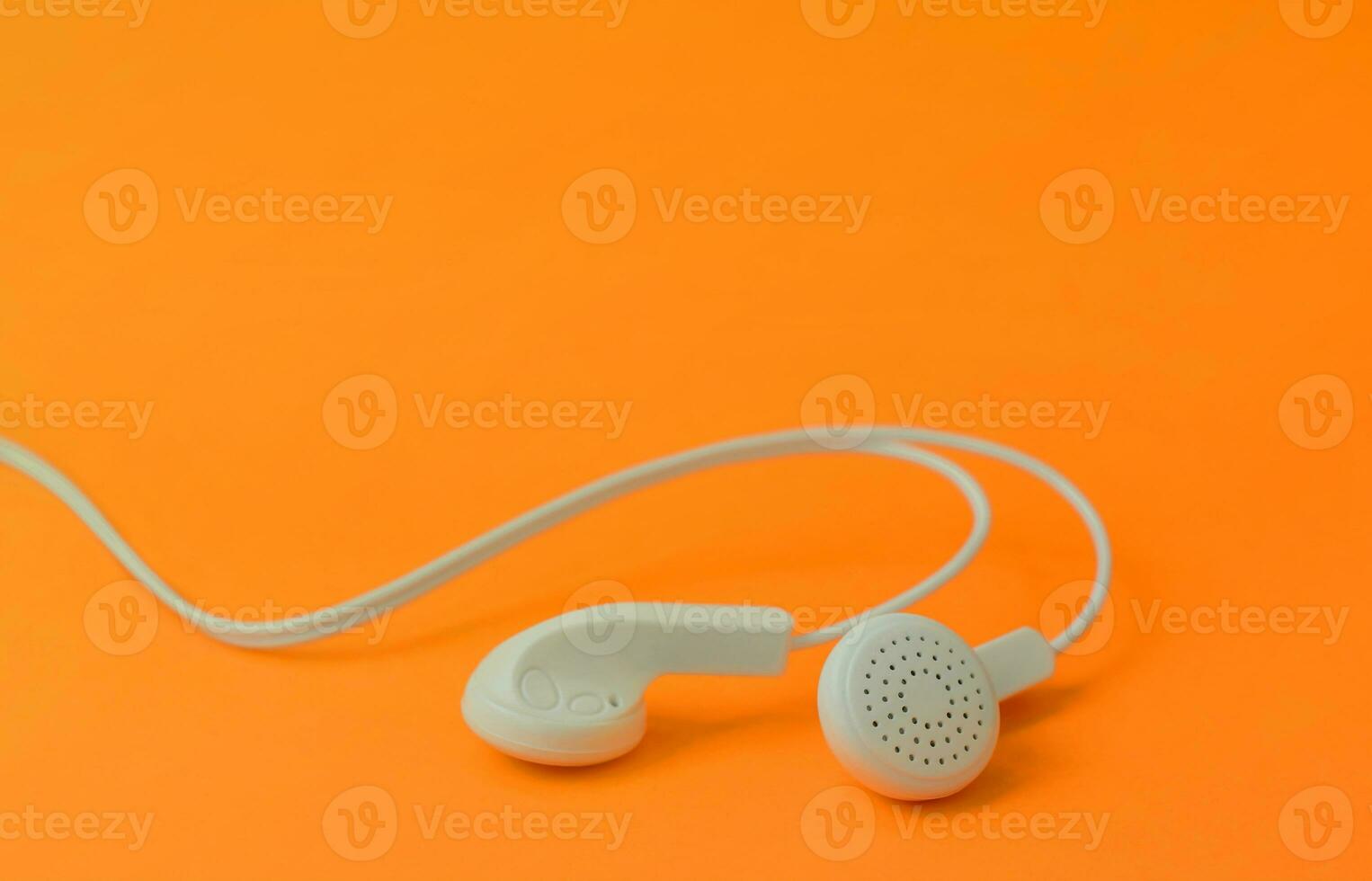 A template for music listening fans. White earphones on red photo