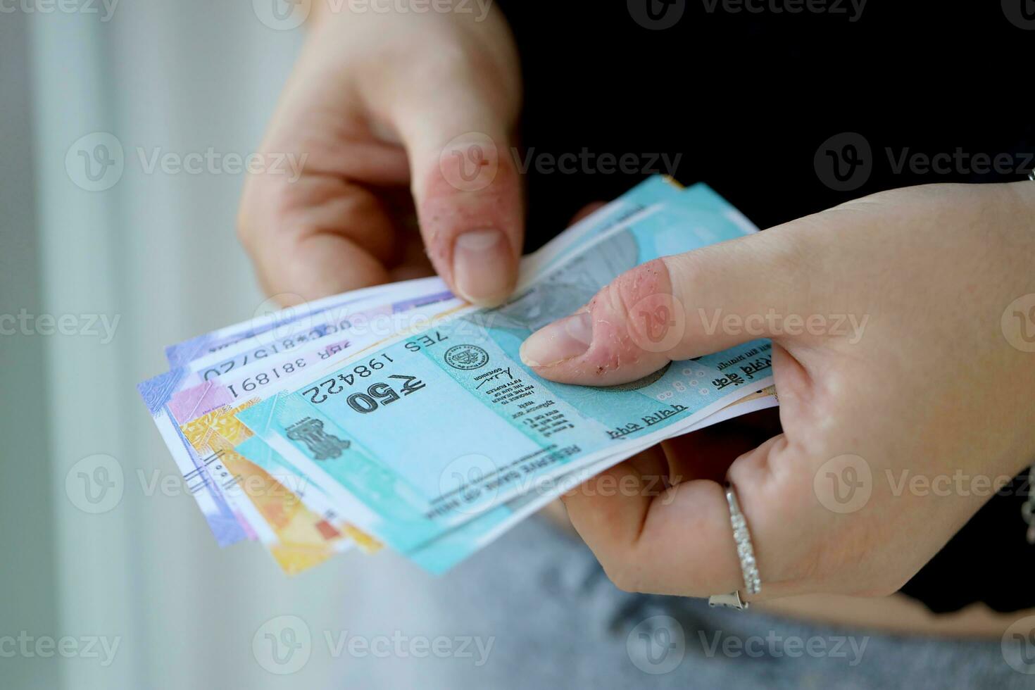 Woman hand with indian rupees bills. Concept of financial operations in cash in India photo