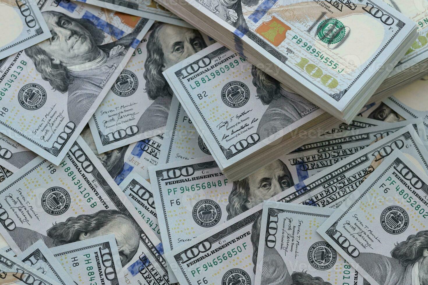 Very big amount of US hundred dollar bills. Huge quantity of united states currency notes on flat table photo