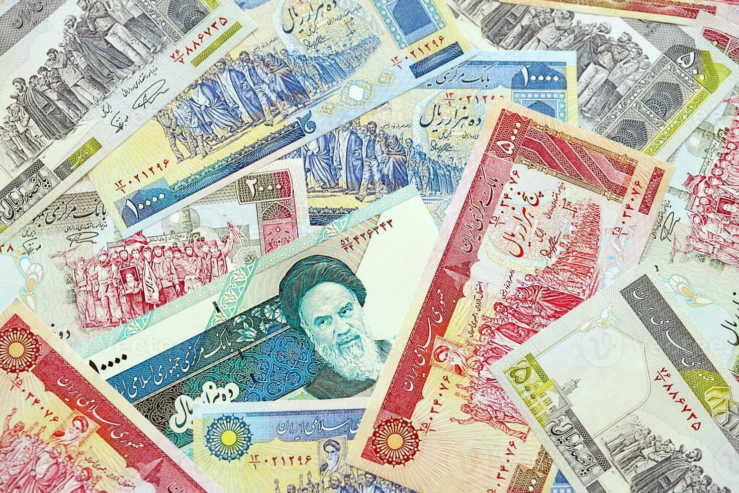 Big pile of Iranian Rial IRR banknotes from Iran as the background on flat surface photo