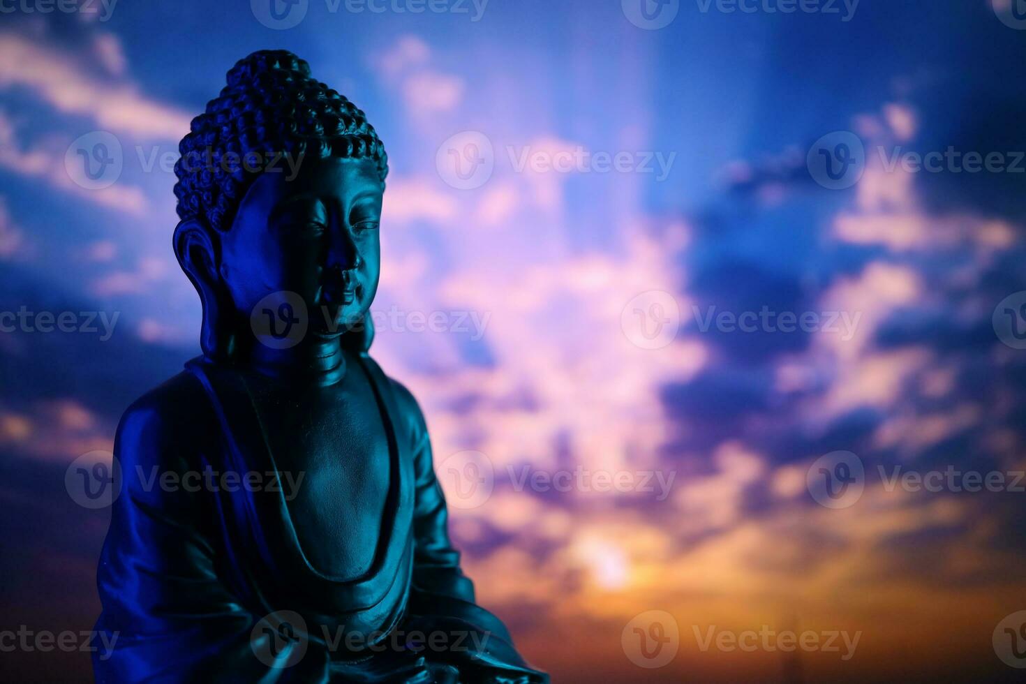 Buddha Purnima and Vesak day concept, Buddha statue with low key light against beautiful and colorful background. Meditation photo