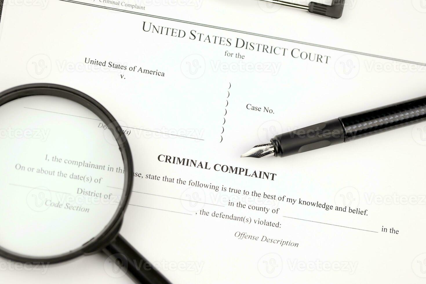 District Court Criminal complaint court papers on A4 tablet lies on office table with pen and magnifying glass photo