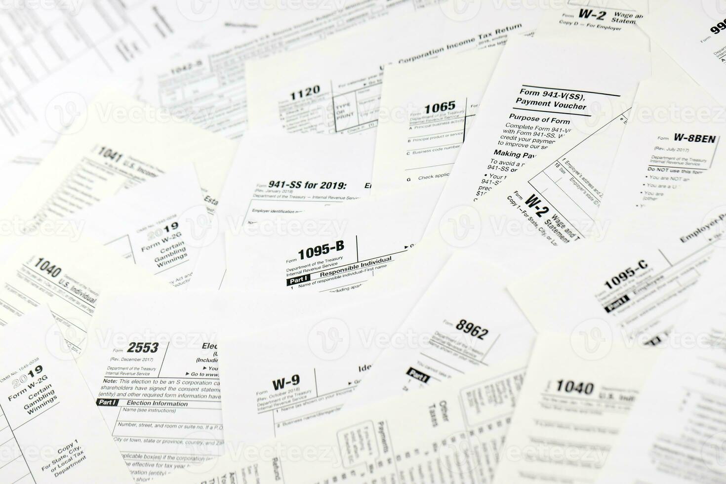 Many tax form blanks lies on table. Tax payers paperwork routine and bureaucracy concept. Need help with tax problems photo