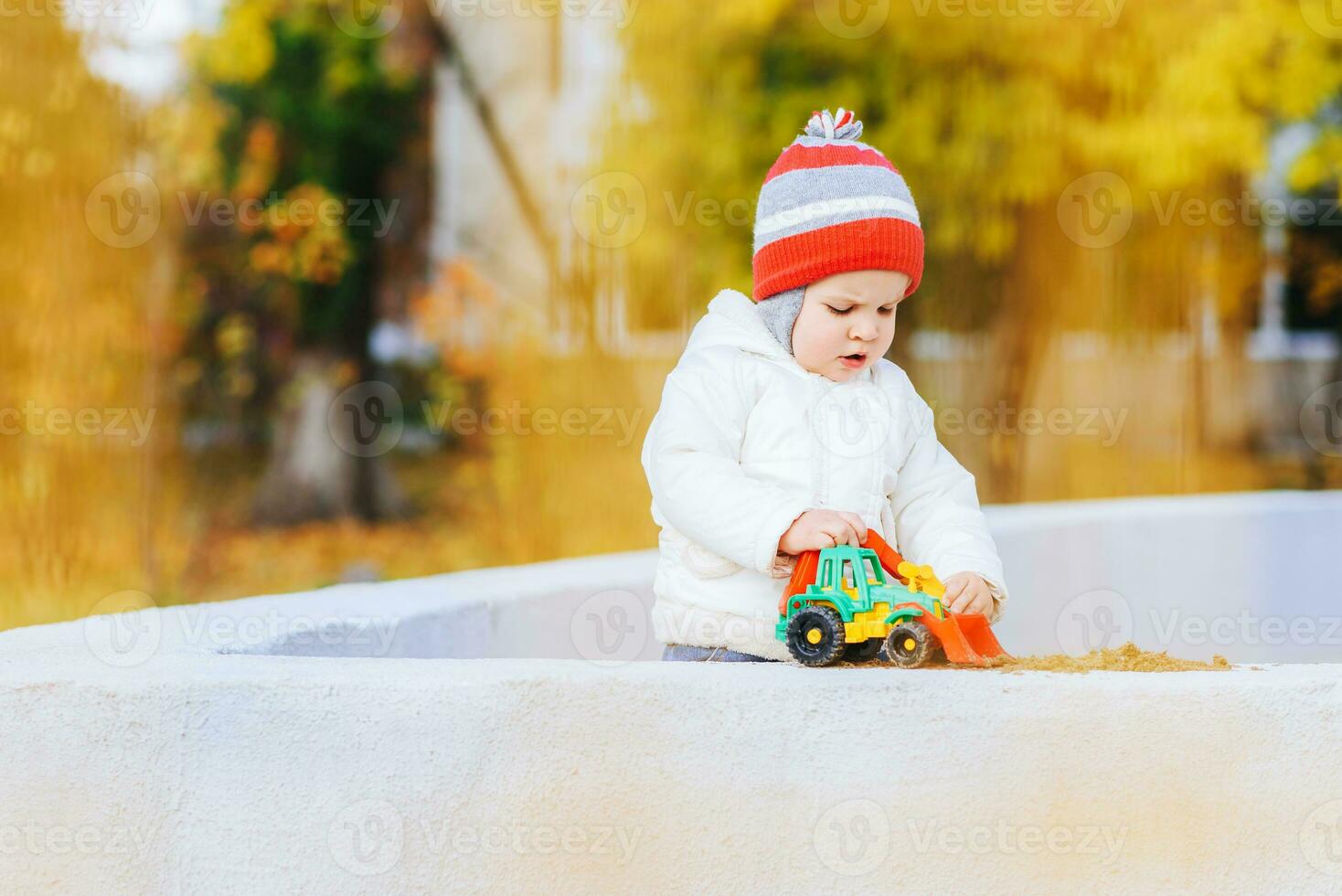 child playing excavator on the street photo