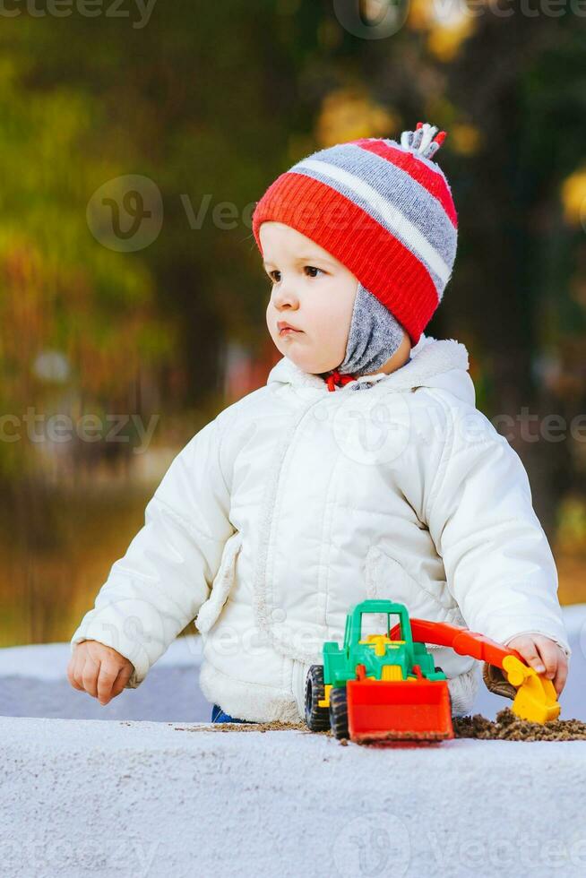 child playing excavator on the street photo