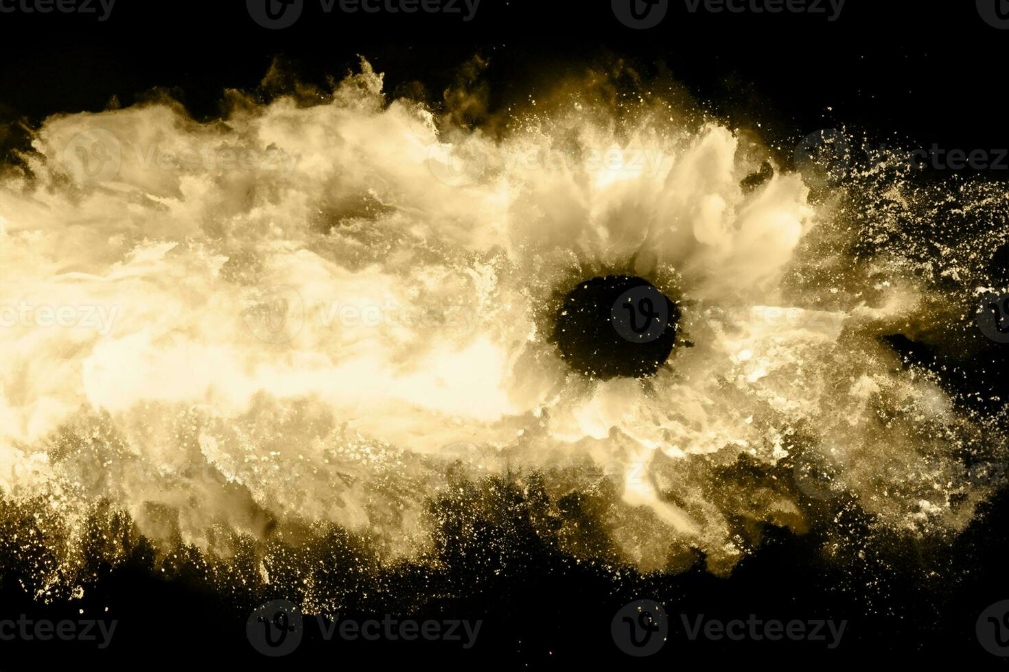 Golden powder explosion on black background. Freeze motion. photo