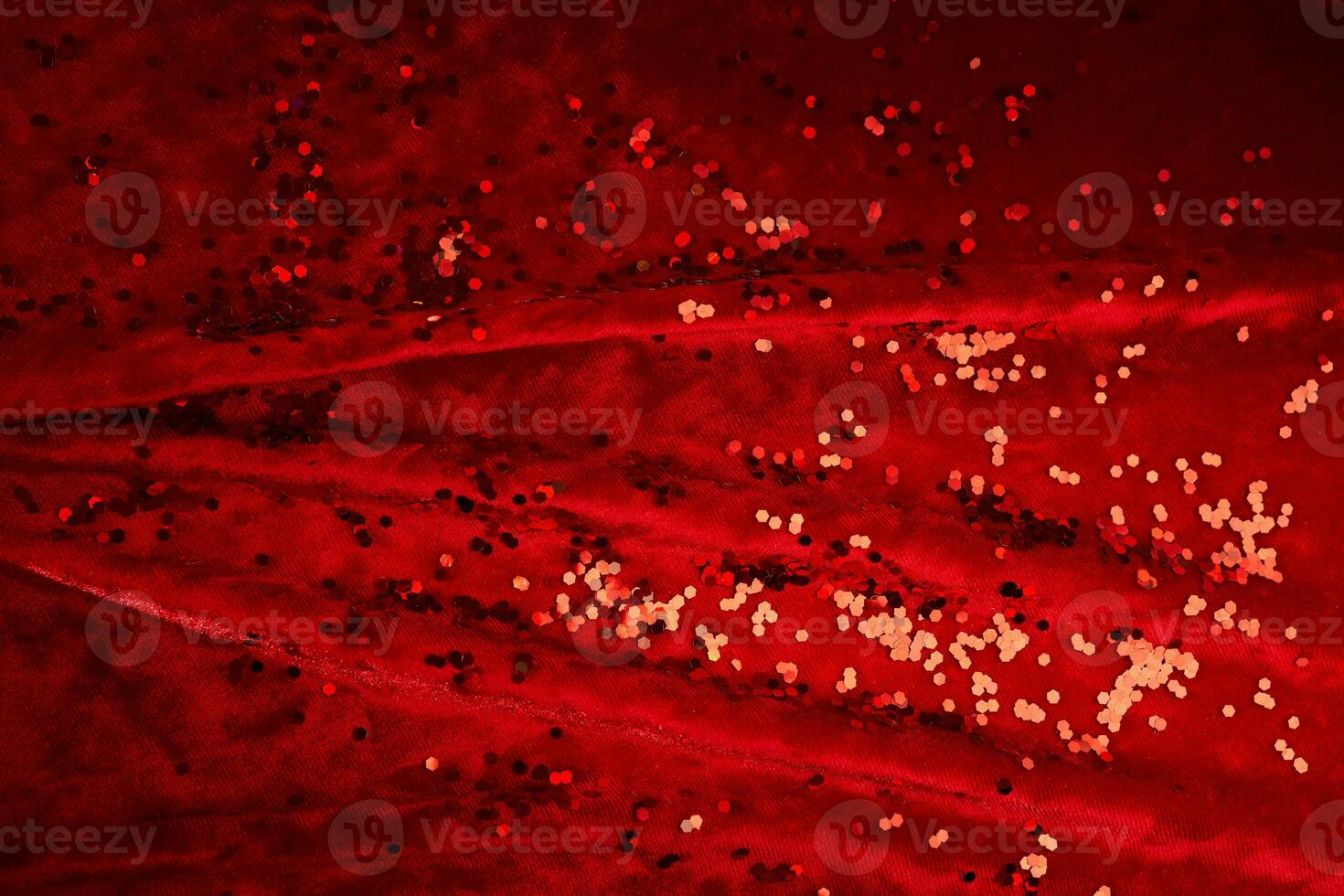 Abstract Christmas background made of red velvet fabric with red sparkles. photo