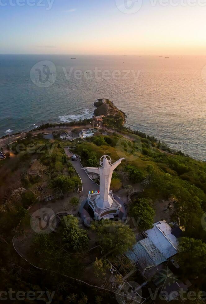 Aerial view of Vung Tau city, Vietnam, panoramic view of the peaceful and beautiful coastal city behind the statue of Christ the King standing on Mount Nho in Vung Tau city. photo