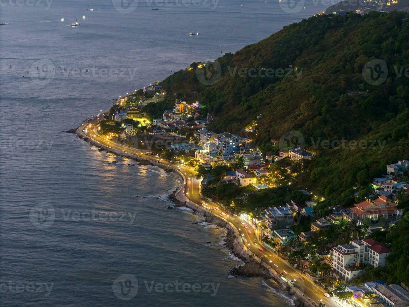 Panoramic coastal Vung Tau view from above, with waves, coastline, streets, coconut trees, Mount Nho in Vietnam behind the statue of Christ the King photo