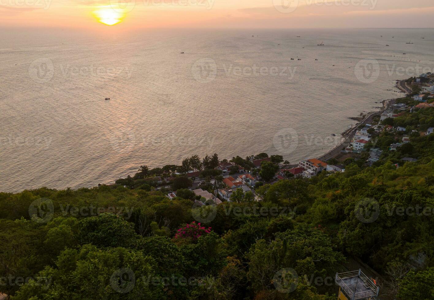 Panoramic coastal Vung Tau view from above, with waves, coastline, streets, coconut trees, Mount Nho in Vietnam behind the statue of Christ the King photo
