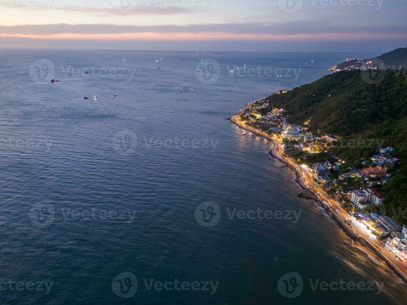 Panoramic coastal Vung Tau view from above, with waves, coastline, streets, coconut trees, Mount Nho in Vietnam behind the statue of Christ the King photo