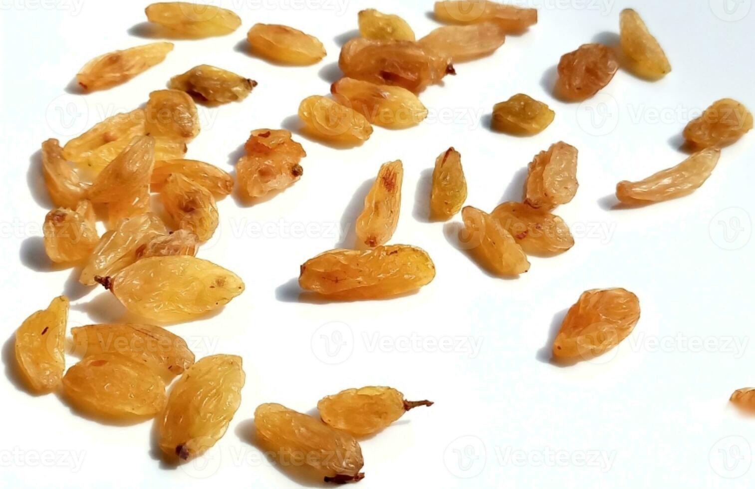 Yellow raisins isolated on white background photo