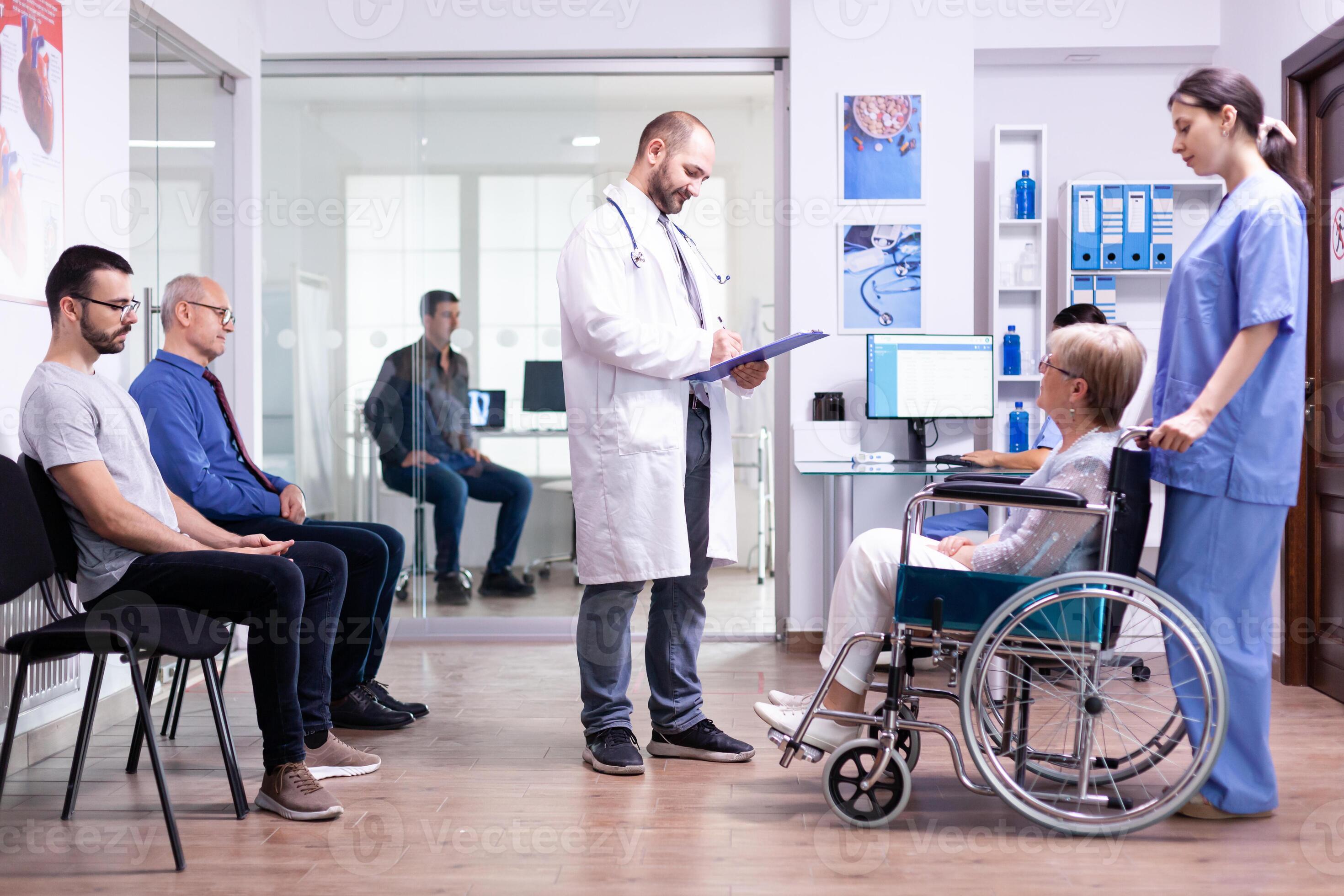 Doctor checking diagnosis of disabled senior woman in wheelchair