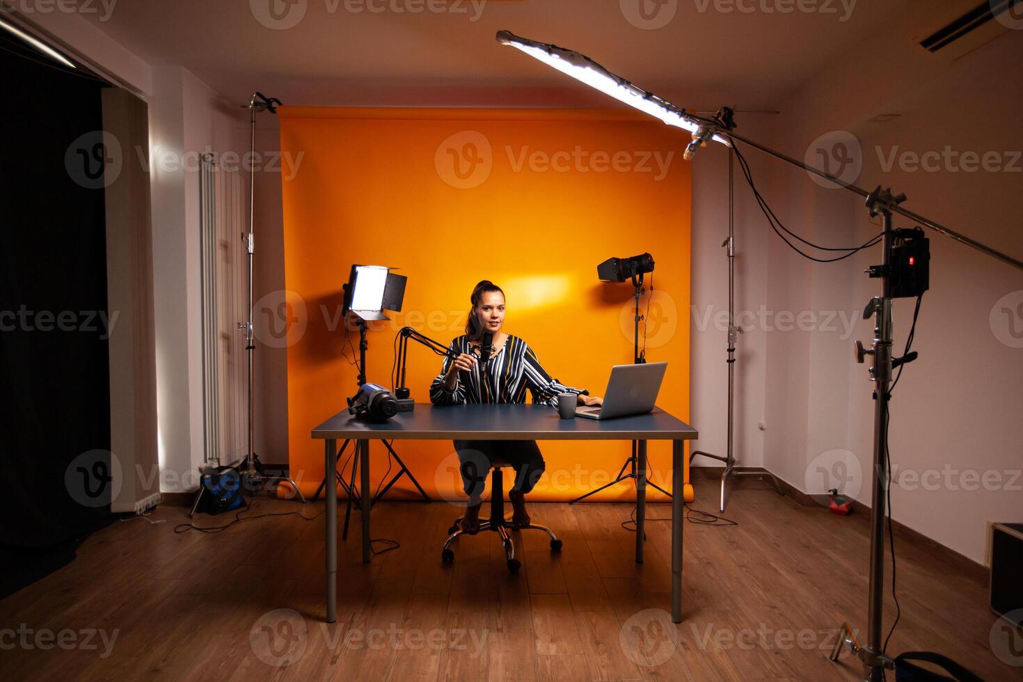 Famous creative woman recording podcast in home studio photo