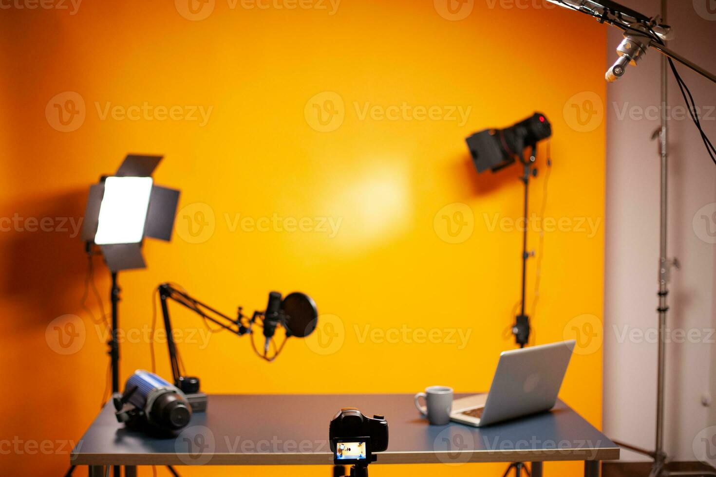 Professional podcast and vlogging setup in studio with yellow background. photo