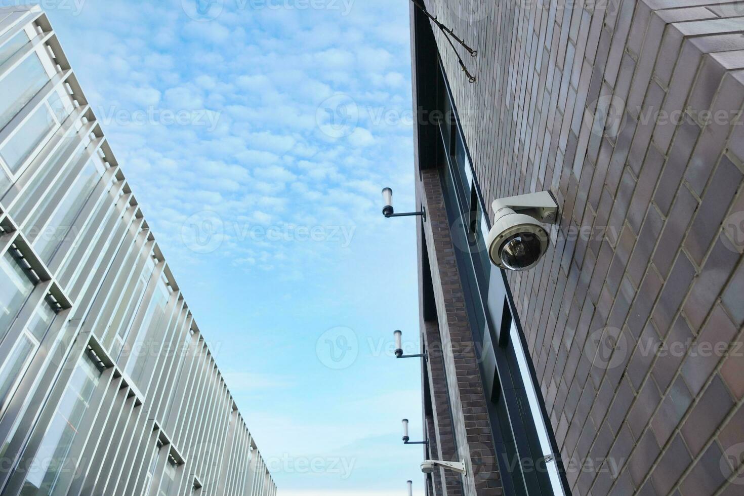 CCTV security camera operating on modern buildings photo