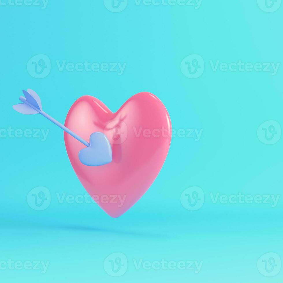 Pink heart pierced by cupid arrow on bright blue background in pastel colors photo